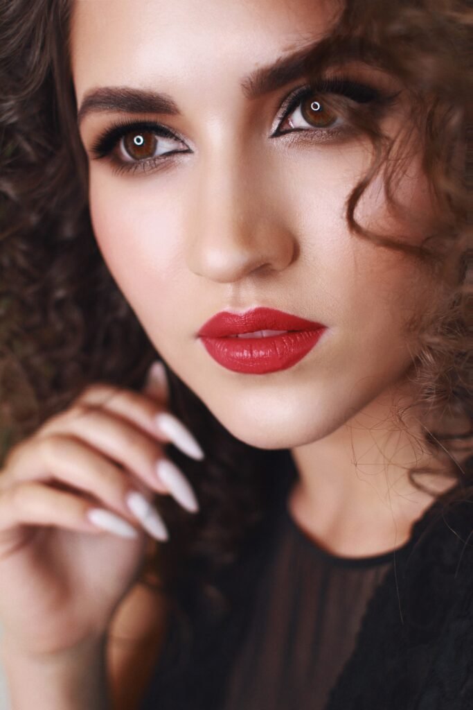 Red lips glam event makeup close-up with glowing skin and smokey eyes in Chicago