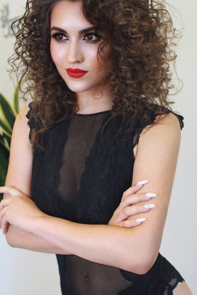 Classic red lips event makeup with voluminous curls and glowing skin in Chicago