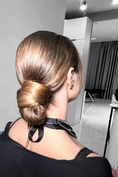 Sleek low bun hairstyle with smooth finish for weddings and evening events in Chicago