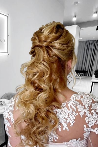 Romantic half-up bridal hairstyle with soft curls and braiding for weddings and events in Chicago
