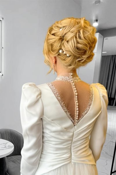 Elegant bridal updo with pearls and soft curls for weddings and events in Chicago