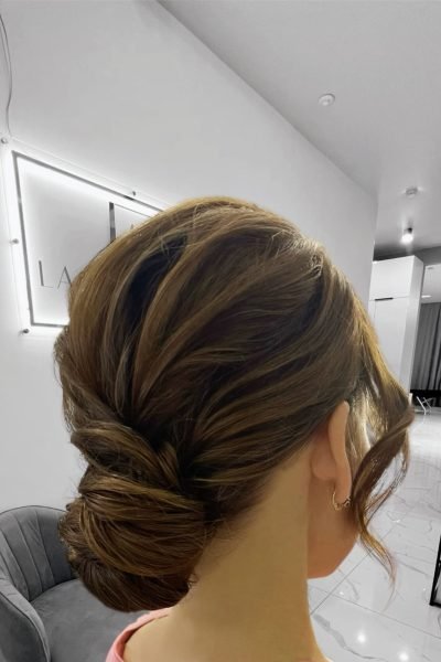 Classic low twist bun event hairstyle with sleek finish and elegant texture in Chicago
