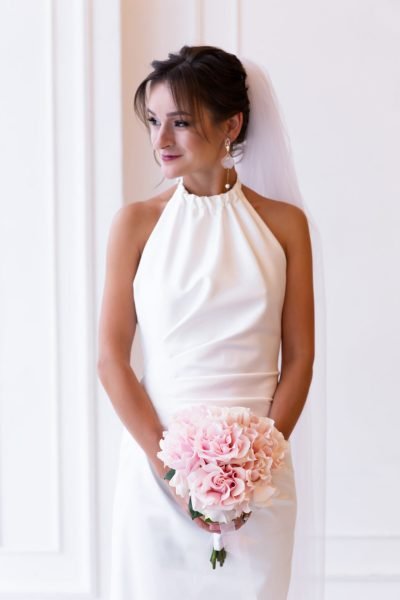 Elegant bridal hairstyle in Chicago with classic low bun and veil by ABC Face