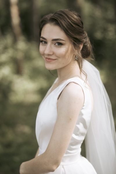 Soft romantic bridal makeup and elegant updo hairstyle by ABC Face in Chicago