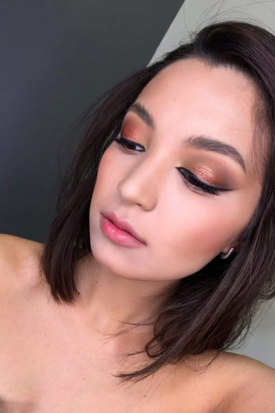 Bronze glam event makeup with shimmer eyeshadow and nude lips in Chicago